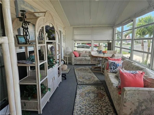 Sunroom / solarium with lofted ceiling and wooden ceiling