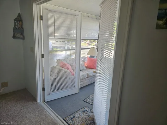 Doorway to outside with carpet