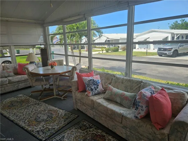 Sunroom featuring lofted ceiling