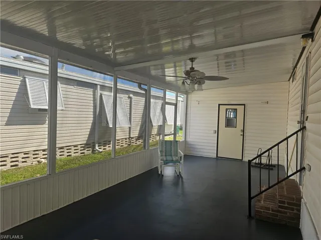 Unfurnished sunroom featuring ceiling fan and a wealth of natural light