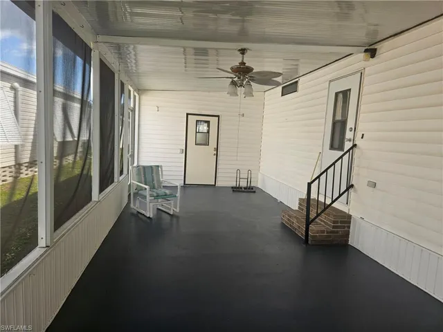 Unfurnished sunroom with ceiling fan