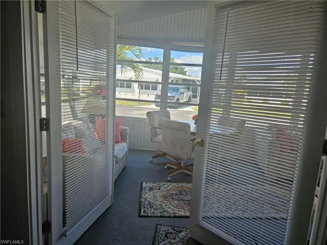 Office area with lofted ceiling and carpet flooring