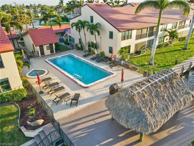 View of pool with a patio area and a community hot tub