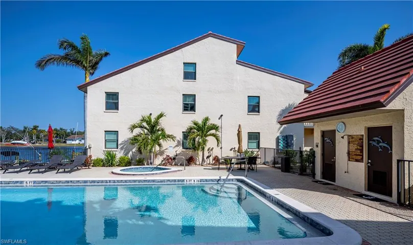 View of pool with a community hot tub and a patio area
