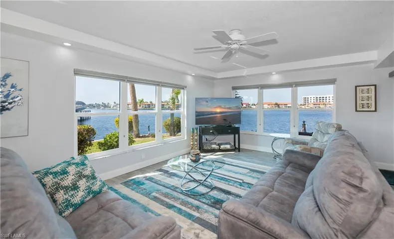 Living room with ceiling fan and wood-type flooring