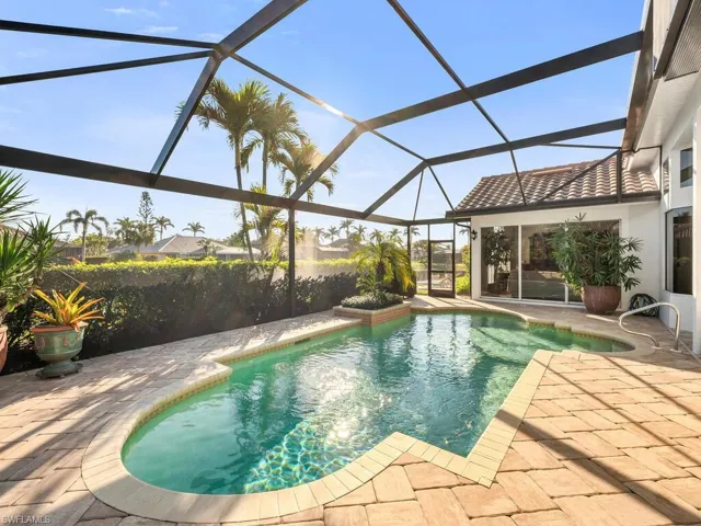 View of pool with a lanai and a patio