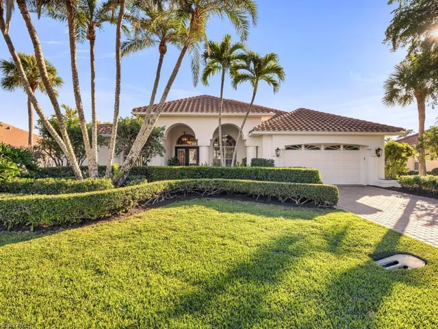 Mediterranean / spanish-style house with a garage and a front yard
