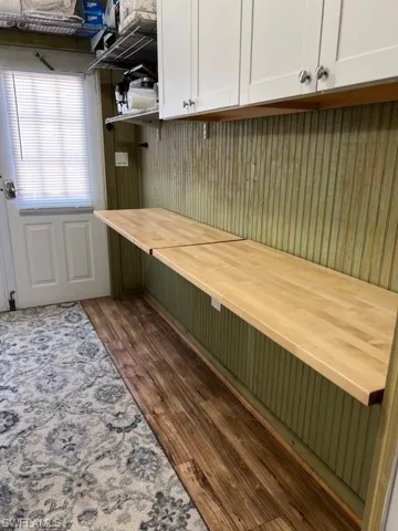 Unfurnished office featuring dark hardwood / wood-style flooring