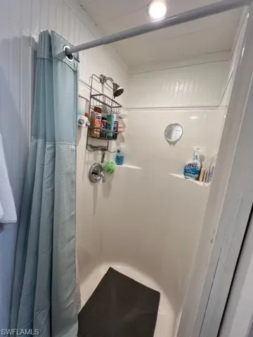 Bathroom featuring a shower with curtain