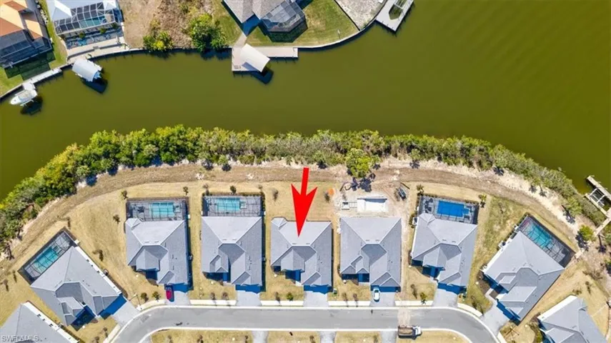 Aerial view of residential area featuring a nearby body of water