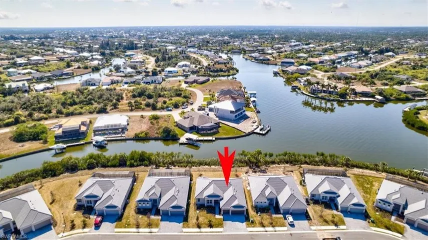 Aerial perspective of suburban area with a nearby body of water