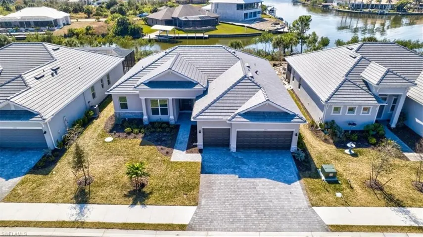 Aerial perspective of suburban area featuring a large body of water