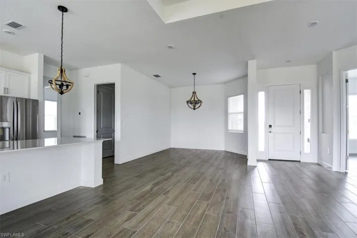 Entrance foyer featuring suspended lighting and wood tiled floors