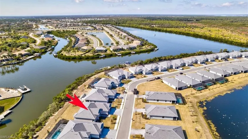Aerial view of property's location with nearby suburban area and a large body of water