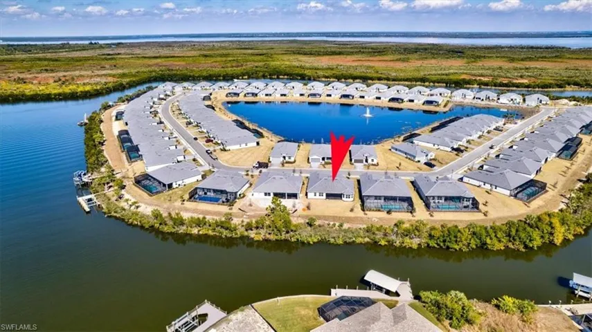 Aerial view of residential area featuring a nearby body of water