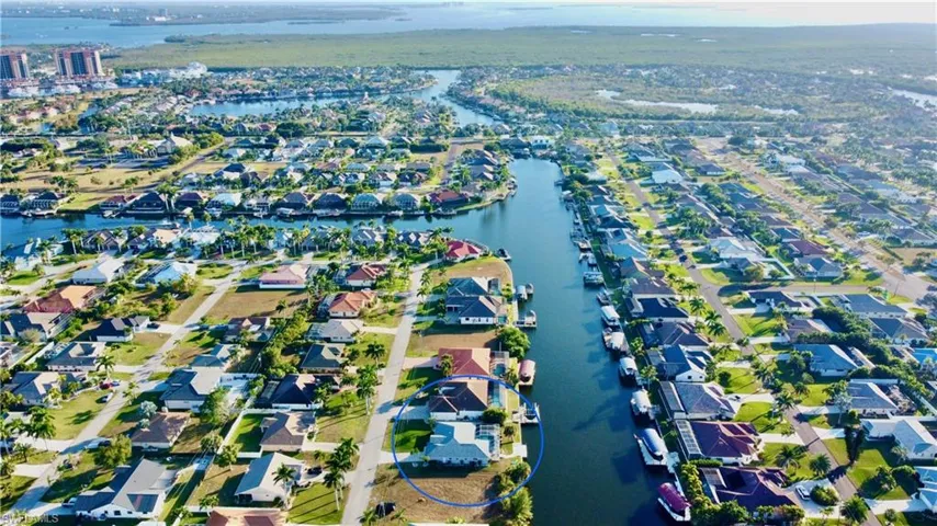 View of property location featuring a nearby body of water and nearby suburban area