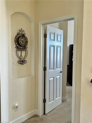 Hallway with light colored carpet
