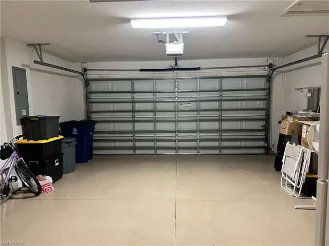 Garage with electric panel and a garage door opener