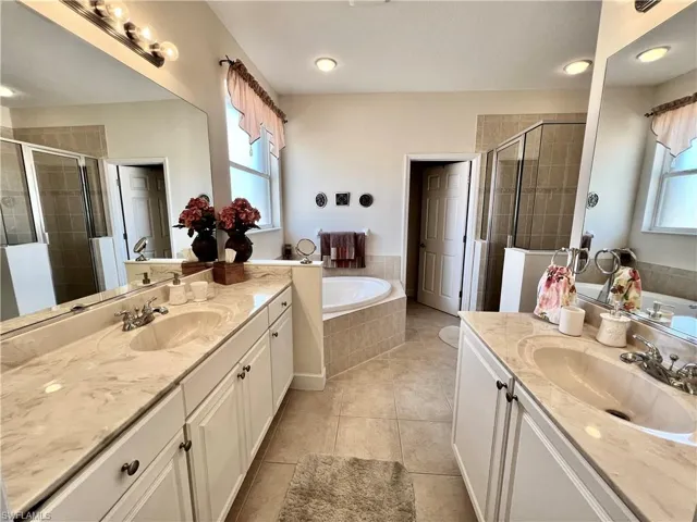 Bathroom with shower, separate bathtub, duel vanities, private comode and walk-in closet