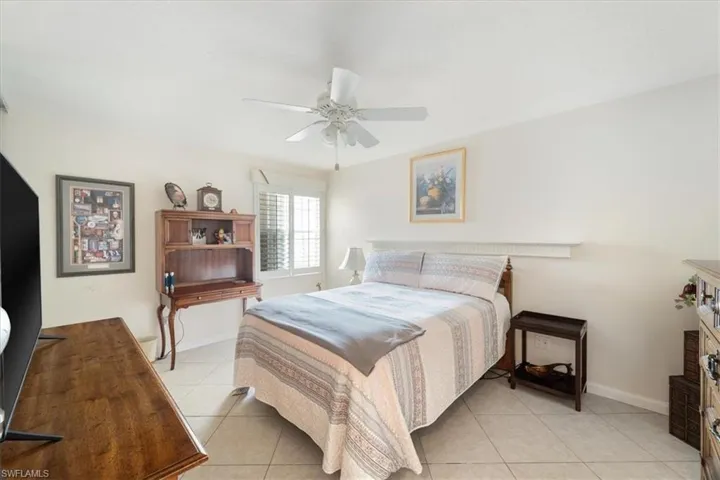 Bedroom featuring light tile patterned floors and a ceiling fan