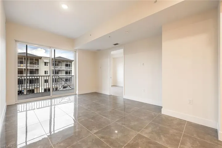 Empty room featuring baseboards, visible vents, and tile patterned flooring