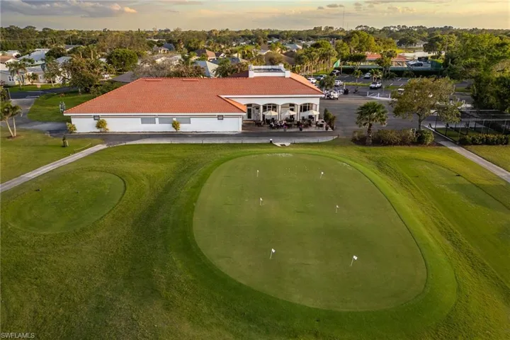 Aerial view at dusk featuring view of golf course