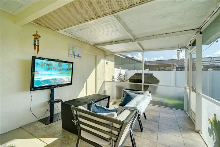 A white vinyl privacy fence along the side of the property