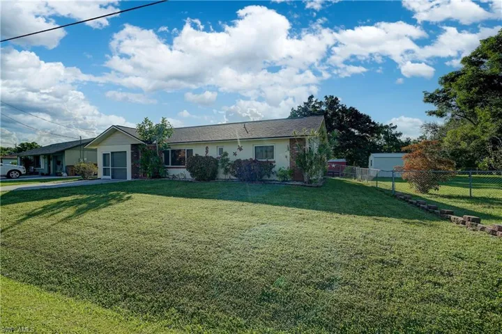 There is also a large front yard with more lush green grass
