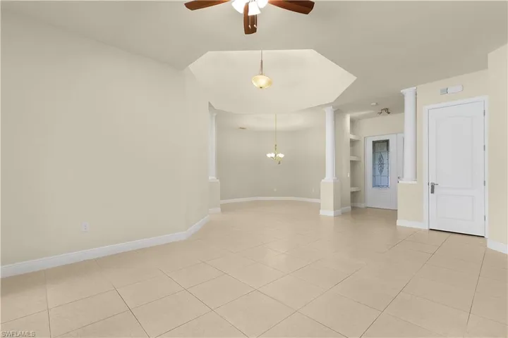 Large sliding glass doors in the living room showcase the pool and lanai.