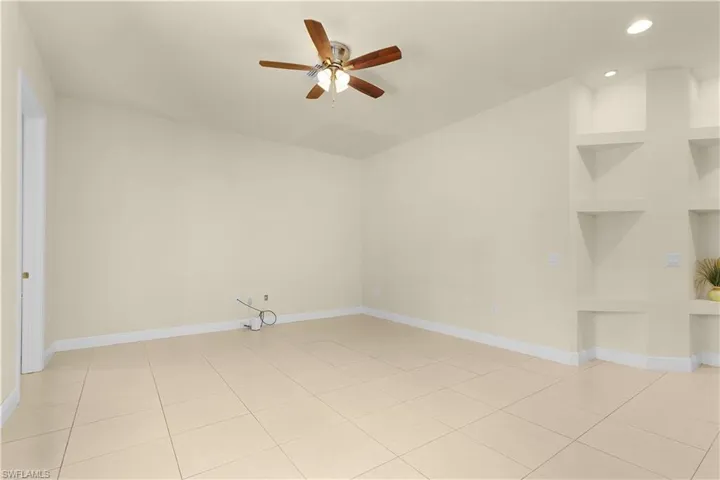 Spacious Primary suite with french doors leading the pool and spa. Flex room shown at the rear of the photo, perfect for an office space, nursery, exercise room or a reading nook.