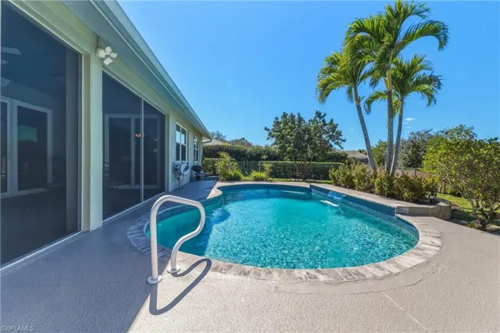 View of pool with a fenced backyard and patio surround