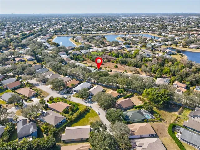 Aerial overview of property's location with nearby suburban area and a large body of water