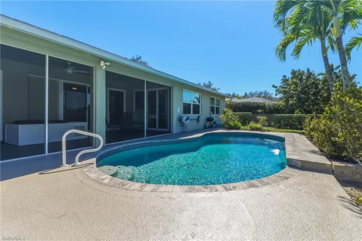 View of pool with a sunroom and patio surround