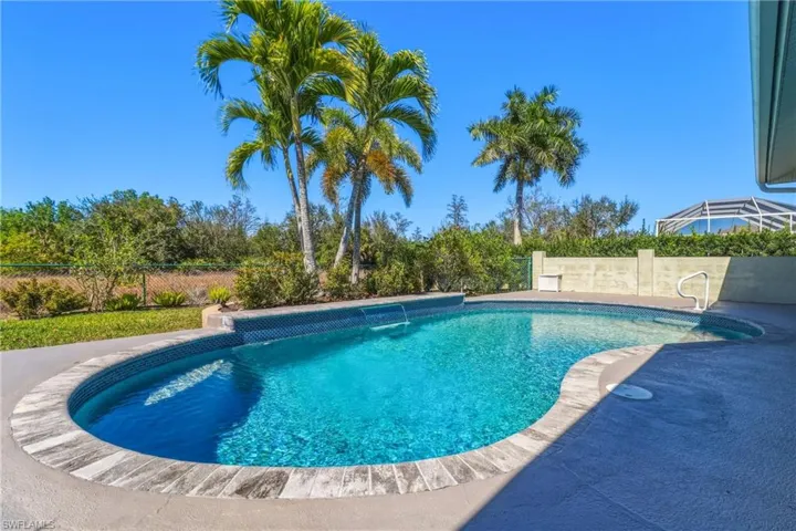 View of pool with a fenced backyard and patio surround