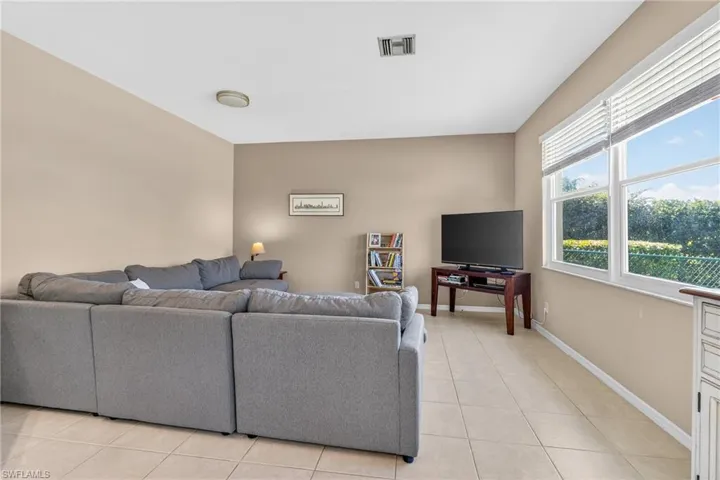 Living area featuring light tile patterned floors and baseboards
