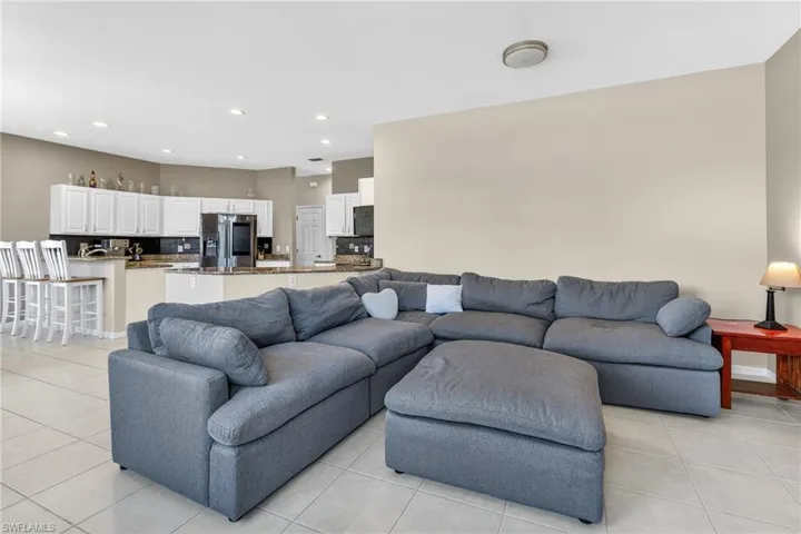 Living area featuring light tile patterned floors and recessed lighting