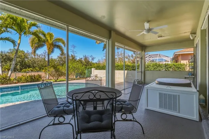 Sunroom with a ceiling fan and outdoor dining space