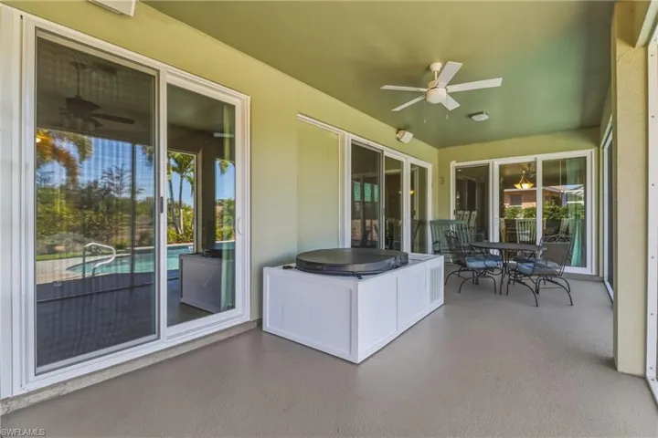 Sunroom with a ceiling fan, outdoor dining space, a patio area, and healthy amount of natural light