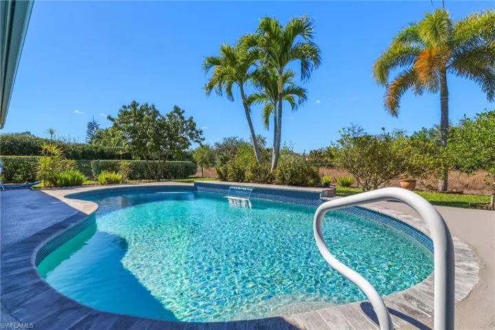 Outdoor pool with a fenced backyard and a patio area