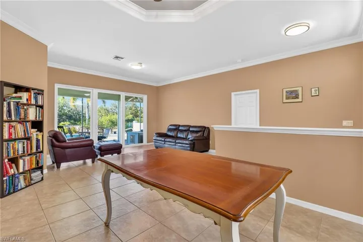 Dining room featuring ornamental molding and light tile patterned floors
