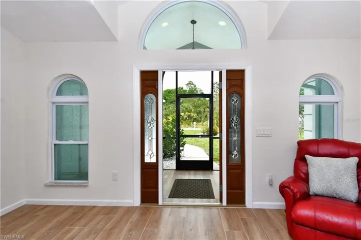 Foyer entrance featuring wood finish floors and baseboards