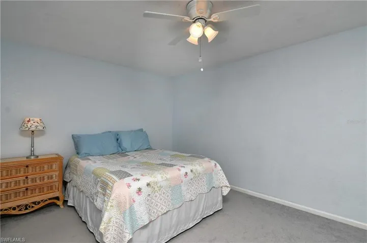 Bedroom featuring light colored carpet and ceiling fan