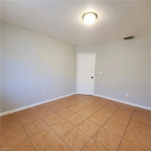 Empty room featuring light tile patterned floors