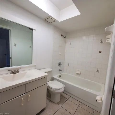 Full bathroom with vanity, tub / shower combination, and light tile patterned flooring