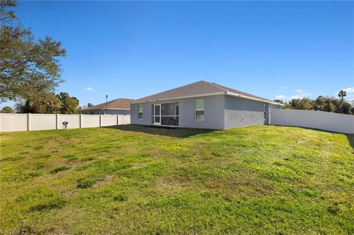 Rear view of property featuring a yard
