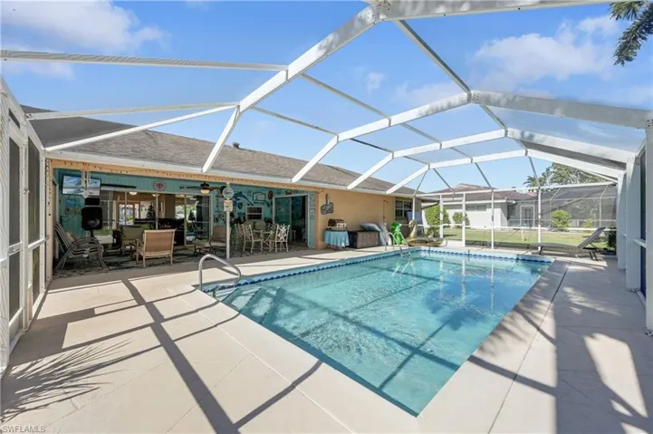 Outdoor pool with a sunroom, a lanai, and a patio