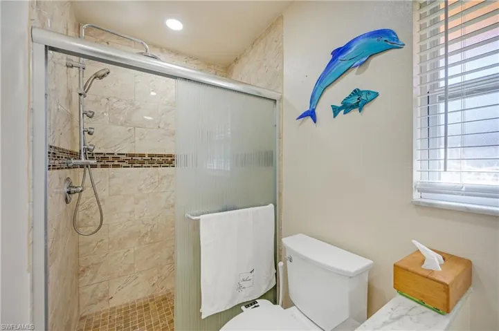 Full bathroom featuring a stall shower