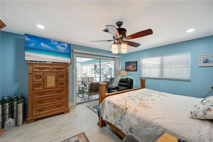 Bedroom with access to exterior, recessed lighting, wood finish floors, and ceiling fan