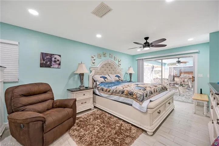 Bedroom featuring a ceiling fan, recessed lighting, and wood tiled floors