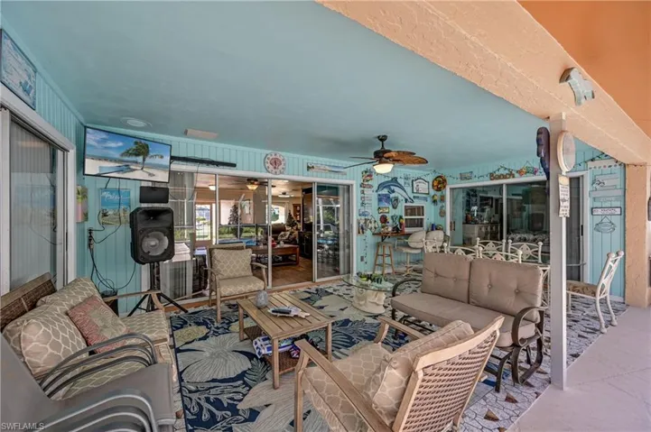 View of patio with outdoor lounge area and ceiling fan